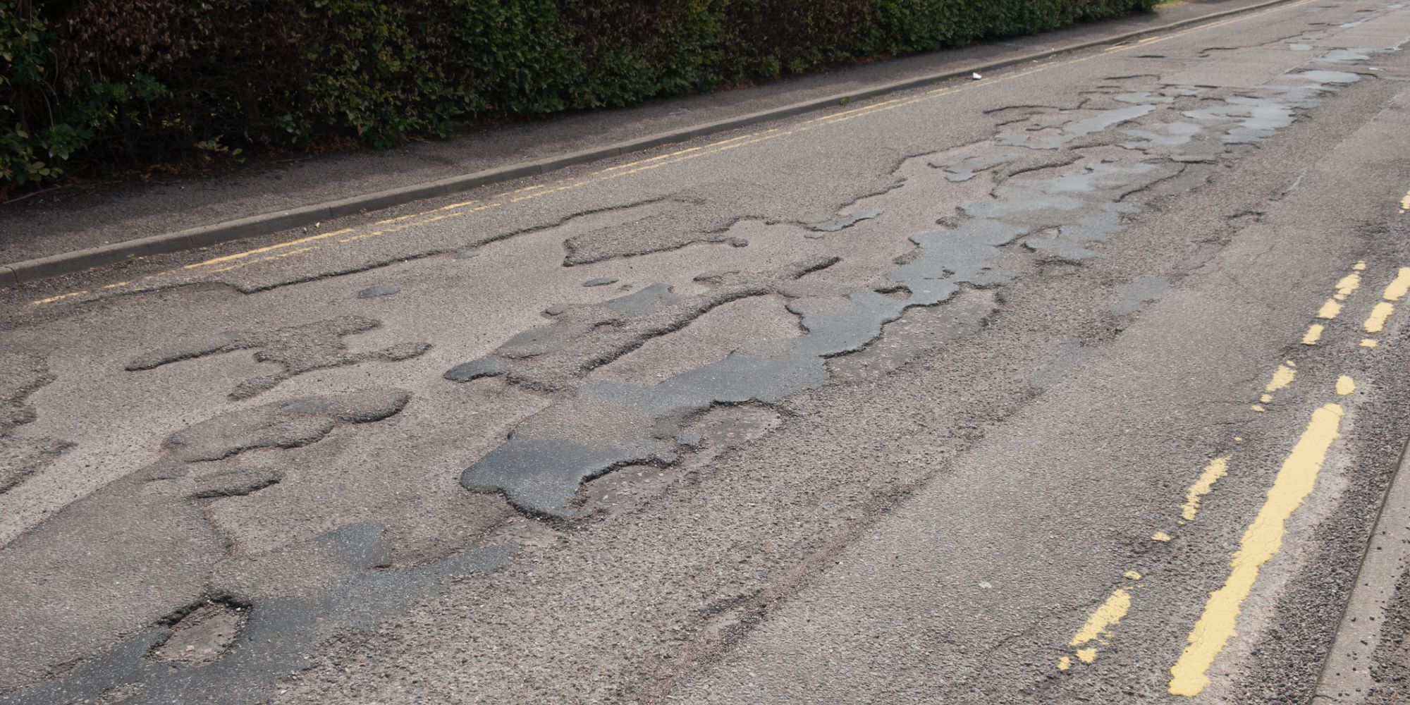 Uneven road surface with potholes